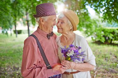 Elderly couple embracing.